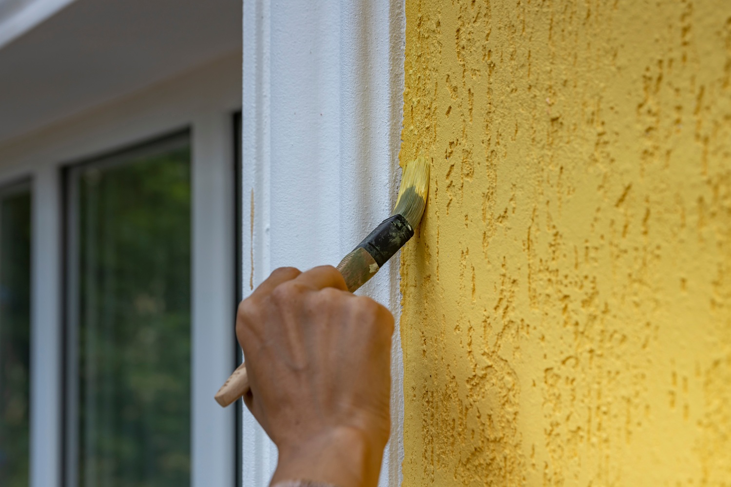 A,Close up,Of,A,Hand,Painting,A,Yellow,Wall,With